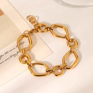 Detailed view of a gold irregular geometric chain bracelet with polished oval links