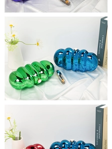 Detail of metallic acrylic cloud clutch with ruched texture in blue and green hues