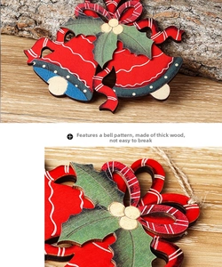 Close-up of durable wooden Christmas bell ornaments with holly and bow on wood background