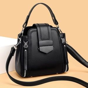 Classic black leather handbag with woven stitching details and detachable shoulder strap