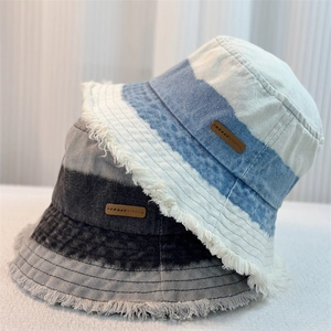 Gradient denim bucket hats with frayed edges in light blue and greyish black colors