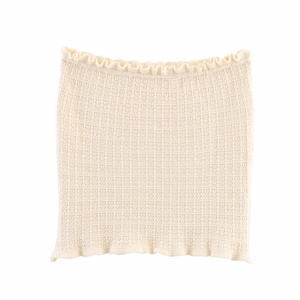 Detail of cream knit tube top with checkered texture and ruffled lettuce edges