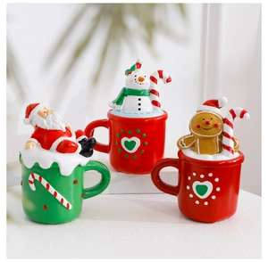 Close-up of Santa and Snowman resin ornaments with Christmas cup festive details