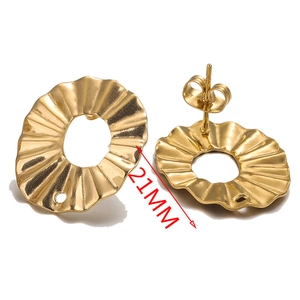 Detailed view of 21mm gold pleated flower stud earrings with wavy metallic texture