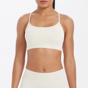 Vue de face de l'ensemble brassière de sport et legging blanc crème pour fitness