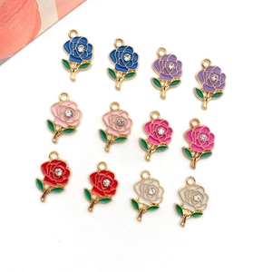 Macro shot of 12 enamel rose pendants with rhinestones in diverse vibrant colors