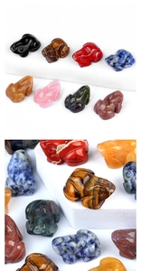 Detailed view of hand-carved natural crystal frog figurines in assorted gemstones