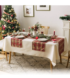 Christmas table runner with red and green plaid snowflakes and festive decor