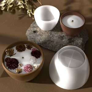Detail of round silicone molds for resin DIY with finished candle jar and dried flower decoration
