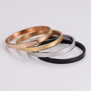 Minimalist checkerboard patterned stainless steel bangles in four metallic colors
