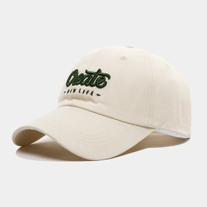 Détail de la broderie 3D verte Create NEW LIFE sur la casquette en coton crème