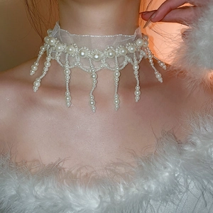 Detailed view of white lace choker necklace with elegant hanging pearl tassels
