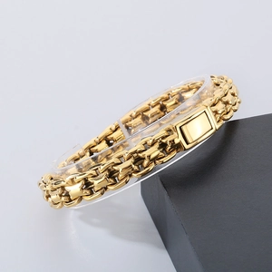 Detail of gold titanium steel curb chain bracelet with square clasp on display stand