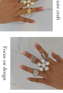 Detailed view of vintage gold and silver pearl rings with modern deconstructed design