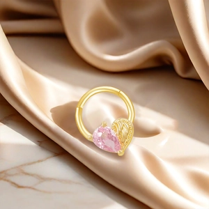 Golden heart-shaped navel ring with pink zircon and wings on champagne silk