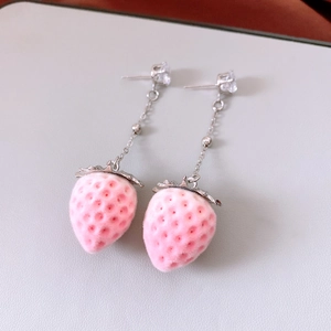 Close-up of sweet pink flocked strawberry drop earrings with shiny zircon studs