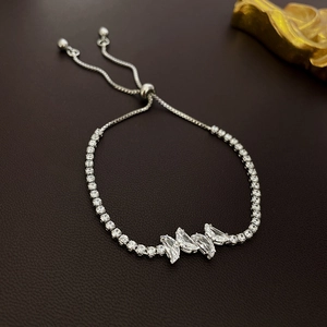 Close-up of adjustable silver tennis bracelet with zircon butterfly and slide clasp