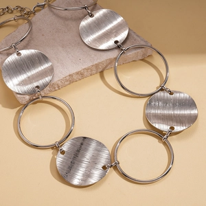 Detail of silver brushed metal circular links and adjustable clasp on stone surface