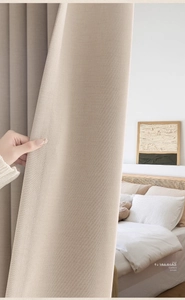 Close-up of beige linen cotton curtains showing thick texture and minimalist natural fibers