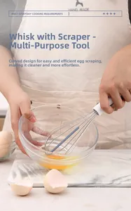 Macro view of stainless steel whisk with silicone scraper blade for baking task