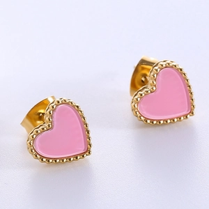 Detail of pink enamel heart earrings with gold beaded edges and polished metal finish