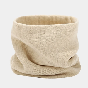 Close-up of beige knitted neck warmer showing soft ribbed texture and premium material