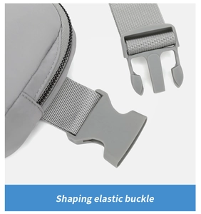 Close-up of grey elastic plastic buckle and nylon webbing strap on crossbody bag