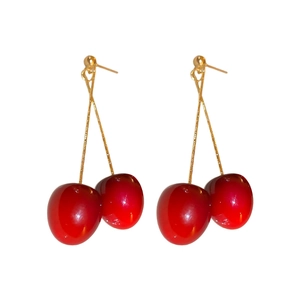 Vibrant red acrylic cherry drop earrings with slender gold hooks on a clean white background
