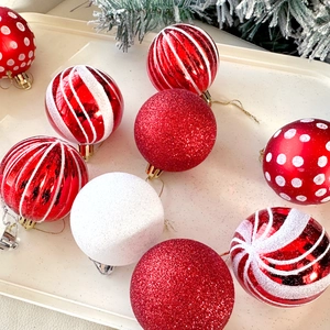 Assorted red and white 6cm Christmas ornaments with glitter and stripes in a tray