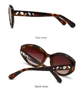 Detail view of tortoiseshell oval sunglasses with rhinestone inlays on temples