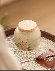 Detail of Ru Kiln ceramic tea canister with rabbit illustration and wooden lid
