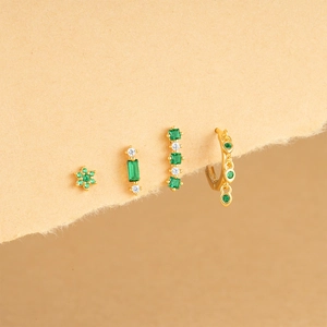 Macro shot of 925 silver flower earrings set with green zircon and opal details