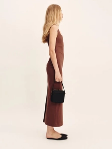 Detailed side view of slim fit dark brown maxi dress with a stylish back slit detail