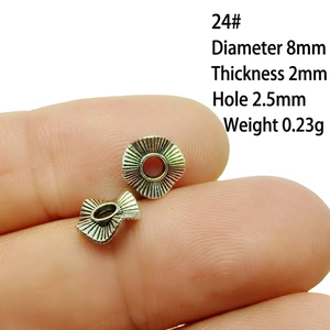 Macro shot of 8mm silver alloy spacer bead with red center for jewelry making