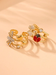 Detail of 18k gold rings with ladybug and dragonfly accents and sparkling zircons