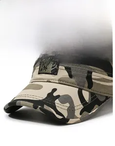 Close-up of camouflage military cap featuring thick brim and shield crest embroidery