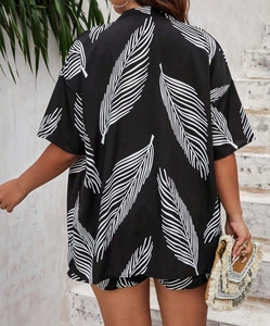 Back view of a casual summer set featuring white palm leaf prints on a black loose outfit