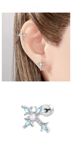 Detailed view of silver cross stud earring with blue stones and secure screw back closure