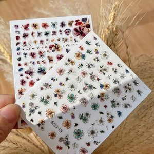 Close-up of JO-1179 floral nail art stickers with vintage botanical and daisy patterns