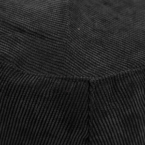 Close-up of black corduroy bucket hat showing thick ribbed texture and neat stitching