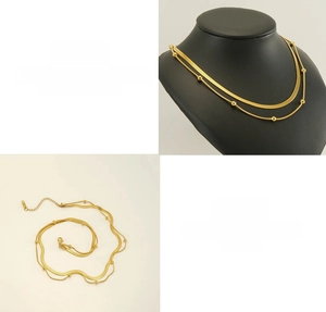 Detail view of dual-layer golden titanium steel snake chains with adjustable clasp