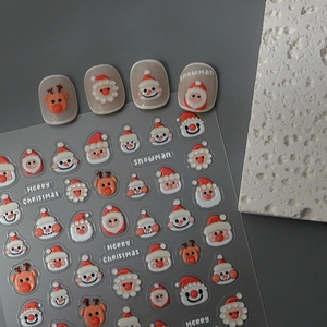 Detail of 3D Christmas nail art stickers featuring Santa, snowman and reindeer designs