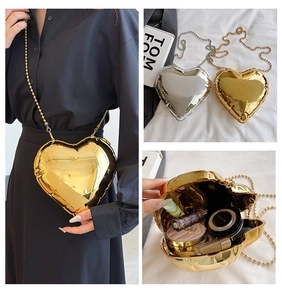 Detailed views of heart-shaped hardshell mini bag with metallic finish and chain strap
