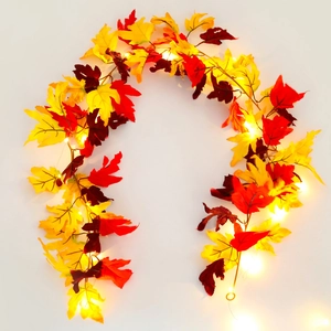U-shaped layout of autumn maple leaf garland with warm yellow LED lights on white background