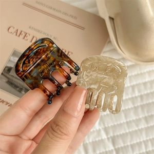 Premium acetate hair claw clips in tortoiseshell and marble beige colors for women