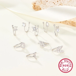 Macro view of assorted 925 sterling silver nose rings and ear clips with zirconia