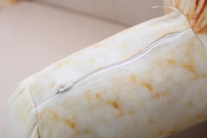 Macro shot of invisible zipper detail on mushroom plush pillow with soft tactile fabric