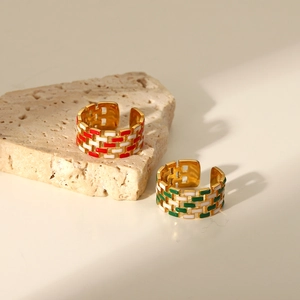 Detail of 18K gold plated checkerboard enamel rings with red and green grid patterns