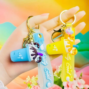 Close-up of cute ice cream cup keychains with Pretty Good wrist straps in blue and yellow