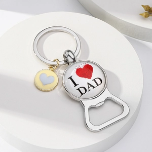 Close-up of polished metal beer bottle opener keychain with I Love Dad heart motif